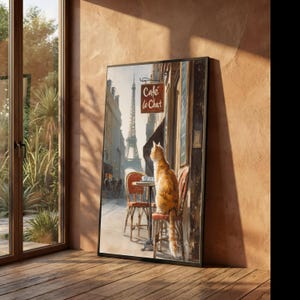 May include: A framed art print showing a ginger cat at a Parisian cafe, looking at the Eiffel Tower. The cafe sign says "Cafe le Chat." The artwork has a warm colour scheme and a vintage feel, creating a sense of nostalgia and Parisian charm.