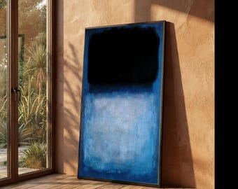May include: A framed abstract painting with a black upper section and a blue lower section. The artwork is leaning against a wall in a room with a wooden floor and a window.
