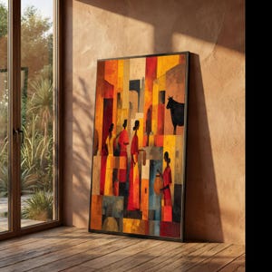 May include: Abstract art print featuring figures in red and yellow garments, set against a backdrop of geometric shapes in warm tones. A black bull stands in the background. The artwork is framed in black and leans against a wall.