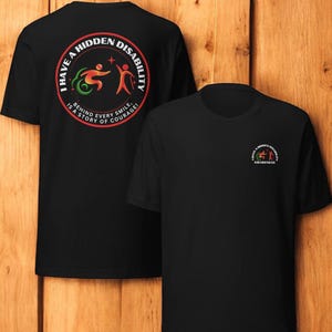 May include: Two black t-shirts with a red circle graphic on the back. The graphic says "I have a hidden disability, behind every smile is a story of courage!" The other shirt has a smaller graphic that says "I have a hidden disability, awareness".