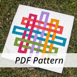 May include: A colorful PDF pattern for a quilt featuring a geometric design with interlocking squares and rectangles in shades of red, orange, yellow, green, blue, and purple. The pattern is displayed on a white background with a subtle speckled texture.