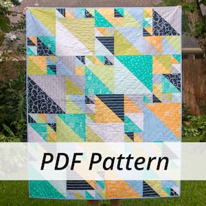 May include: A colorful quilt with a geometric pattern of triangles in shades of blue, green, yellow, and gray. The quilt is hanging on a clothesline in a backyard setting. The text "PDF Pattern" is visible at the bottom of the image.