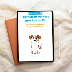 May include: A digital tablet displays "Toby's Beginner Nose Work Starter Kit" with a cartoon dog illustration. The kit includes "5 Fun Scent Activities for Dogs & Their Humans." A white stylus and an orange notebook are next to the tablet.