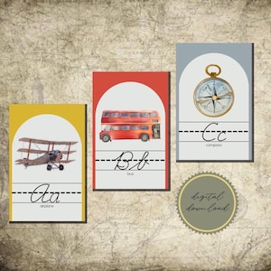 May include: Three rectangular educational cards featuring an airplane with the letters Aa, a red double-decker bus with the letters Bb, and a gold compass with the letters Cc. Each card displays the corresponding word below the cursive letters.