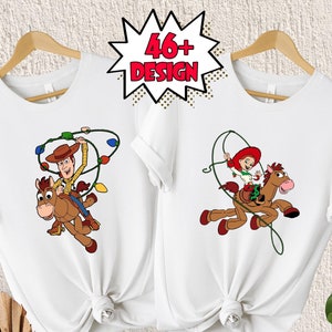 May include: Two white t-shirts with a cartoon image of Woody and Jessie from Toy Story riding a horse. Woody is wearing his cowboy hat and vest, and Jessie is wearing her red dress and hat. The shirts are tied together in a knot.