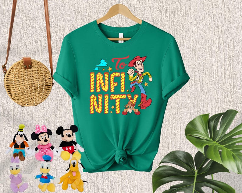 May include: Green t-shirt with a cartoon image of Woody from Toy Story. The shirt has the text "To Infinity and Beyond" printed on it.