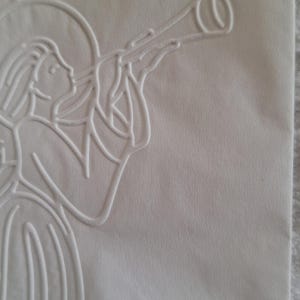 Pu&ograve; includere: Immagine in rilievo bianca di un angelo che suona la tromba. L'angelo &egrave; raffigurato di profilo, con un'aureola e vesti. L'immagine &egrave; su carta bianca sporca strutturata.