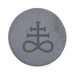 May include: A round, gray slate coaster featuring a dark gray Leviathan Cross symbol. The coaster has a natural, textured surface and is designed to protect surfaces from drink condensation.