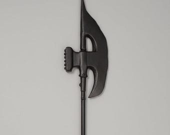 May include: A black halberd, a pole weapon combining an ax, a hook, and a spear point. The ax blade has a curved edge, and the spear point is at the top. The weapon is made of metal and has a long, slender pole.