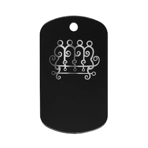 May include: Black dog tag pendant with a silver-colored ornate design. The design features a series of connected figures with swirling details. The tag has a rounded top with a hole for a chain.