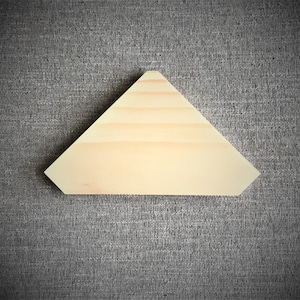 Puede incluir: Una forma triangular de madera clara con una superficie lisa.
