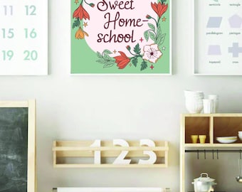 May include: A framed print with the words "Home Sweet Home-school" in a floral wreath. The image is on a light green background. Other framed prints with numbers and shapes are also visible, along with a miniature kitchen and desk.