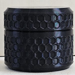 Small Travel Container with screw on lid.