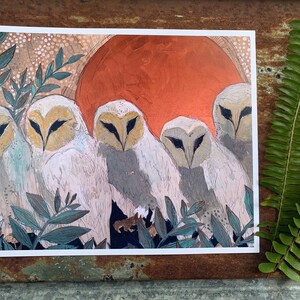 May include: A painting depicting five white owls with orange eyes, perched in front of a large orange sun. The owls are surrounded by green foliage.