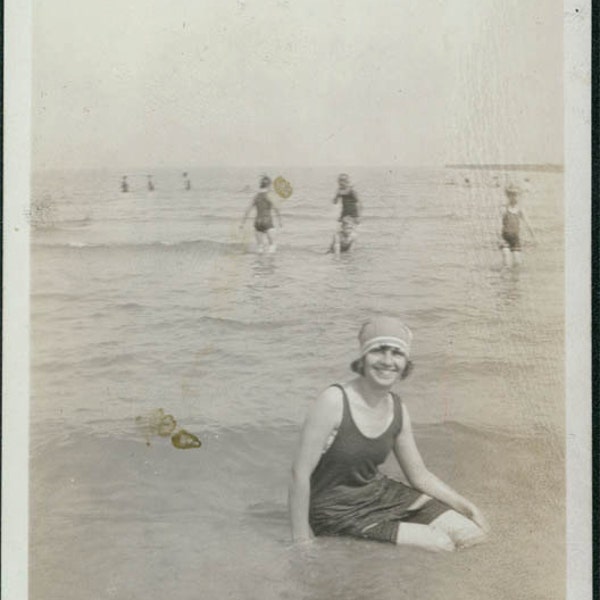 1918 a Woman in Swim Suit smiles from oceans edge vintage photo