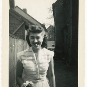 vintage photo 1949 Pretty Lady in Sheer Dress Holds Flower Bouquet Sticks Tongue Out