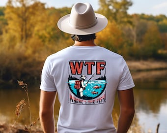 Puede incluir: Camiseta blanca con un gráfico de un pescador con el texto "WTF WHERE'S THE FISH!" impreso en la espalda.