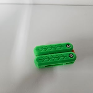 May include: A green folding pocket knife with a textured handle and silver screws.