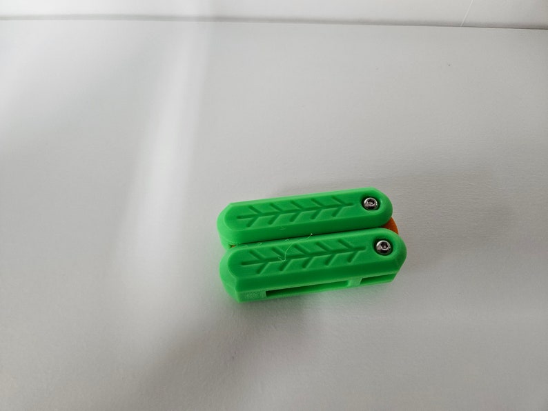 May include: A green folding pocket knife with a textured handle and silver screws.