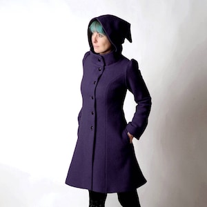 May include: A purple hooded coat with a button-up front and a flared skirt. The coat has a high collar and a pointed hood.