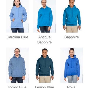 May include: A collection of hooded sweatshirts in various shades of blue, including Carolina Blue, Antique Sapphire, Sapphire, Indigo Blue, Legion Blue, and Royal. Each hoodie features a front pocket and a drawstring hood.