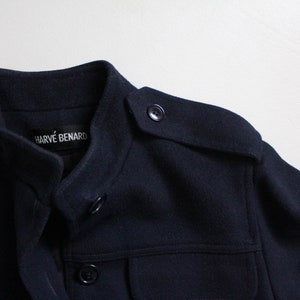 May include: A navy blue jacket with a stand-up collar and a label that reads "Harv&eacute; Benard".
