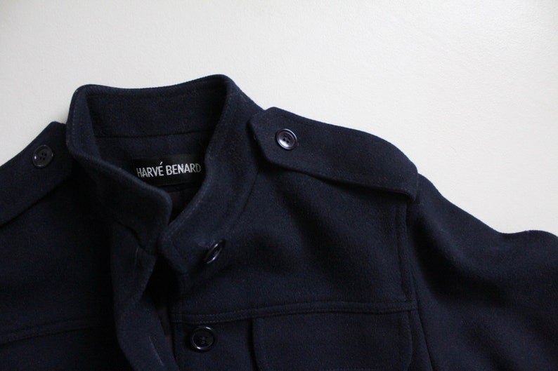 May include: A navy blue jacket with a stand-up collar and a label that reads "Harv&eacute; Benard".