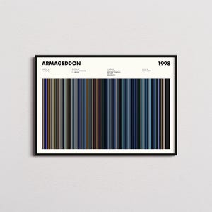 Puede incluir: Un póster enmarcado con el título "Armageddon" y el año "1998" en la parte superior. El póster presenta barras de color verticales en varios tonos de azul, marrón y gris. El póster tiene un marco negro.