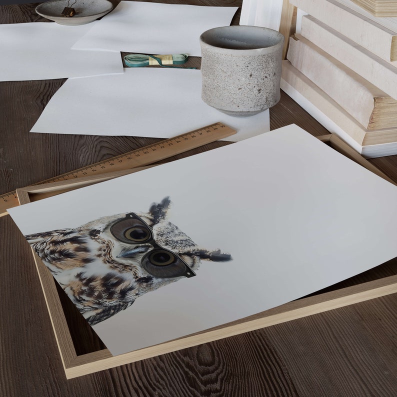 May include: A framed print of a brown and white owl wearing black-rimmed glasses. The owl is looking directly at the camera with a serious expression.