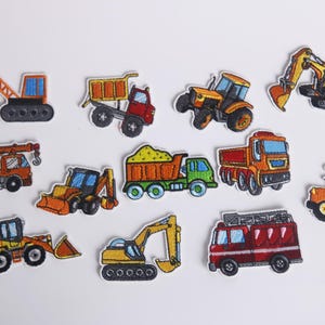 May include: A set of ten embroidered iron-on patches featuring various construction vehicles, including a crane, dump truck, tractor, excavator, and bulldozer. The patches are colorful and detailed, with a cartoon-like style.