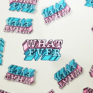 May include: Multiple pink and blue embroidered iron-on patches with the text "WHAT EVER" in a 3D style.