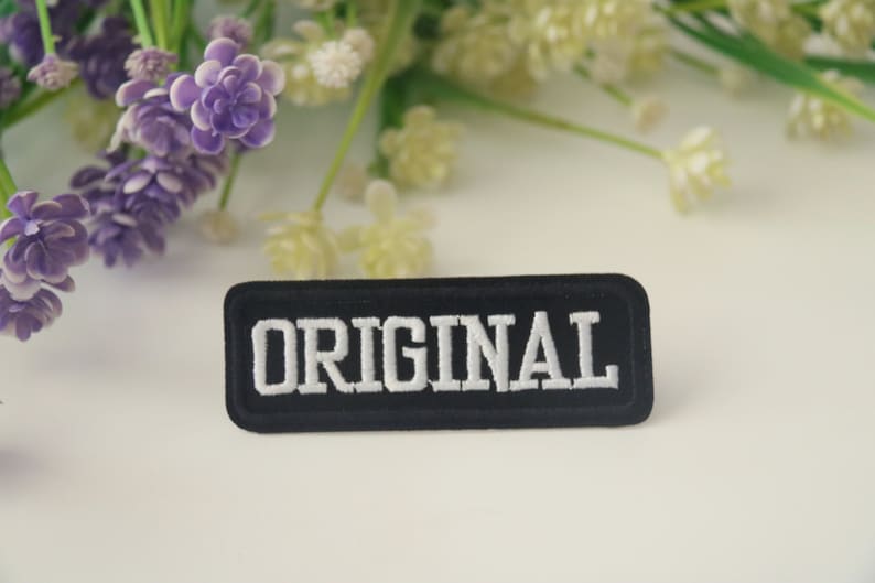 May include: Black embroidered patch with white lettering that reads "ORIGINAL".