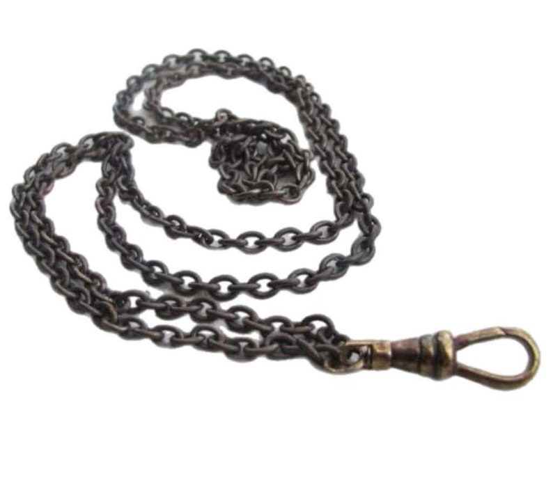 May include: A silver-toned pocket watch chain with a brass clasp. The chain is made of linked oval shapes.