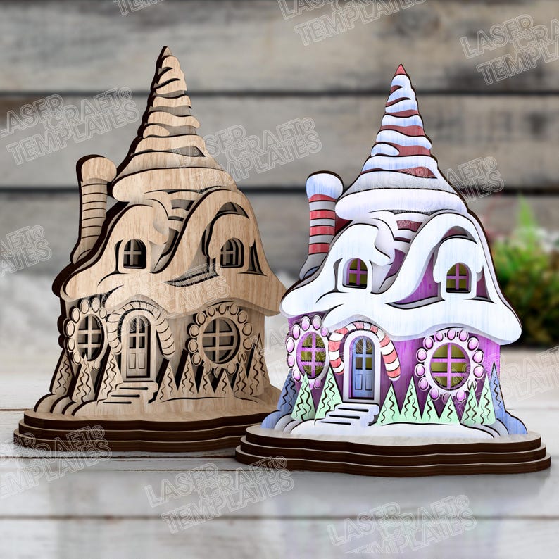 May include: Two wooden laser-cut decorative houses. One is natural wood, the other is painted pink, white, and red. Both have detailed windows, doors, and chimneys. The houses are designed with a whimsical, fairytale aesthetic.