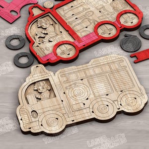 May include: Wooden fire engine puzzle in red and natural wood. The puzzle features a firefighter in the driver's seat and includes fire fighting tools. The design is laser cut and includes several removable pieces.