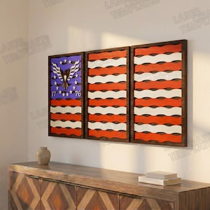 May include: A three-panel wooden wall art piece depicting the American flag. The first panel features a blue field with stars and an eagle, while the other two panels display red and white stripes. The artwork is framed in dark brown.