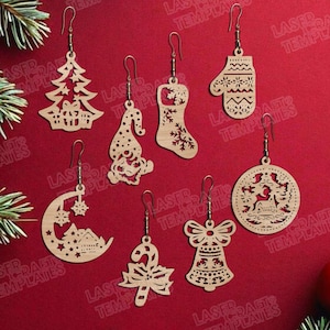 May include: A collection of wooden Christmas-themed earrings. Designs include a Christmas tree, gnome, stocking, mitten, crescent moon with a house, candy cane, bell, and a round ornament with a deer and tree. Each earring has a gold-colored hook.