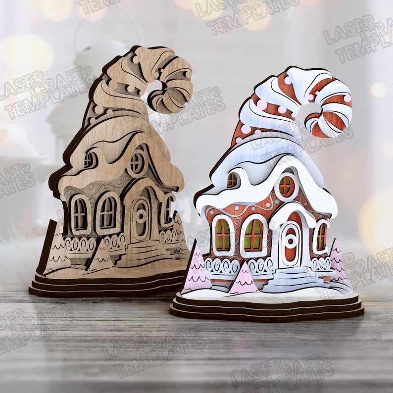 May include: Two decorative wooden Christmas village houses. One is unfinished wood, the other is painted red, white, and pink with a snowy roof. Both have a whimsical, curved hat-like top and are on a wooden base.