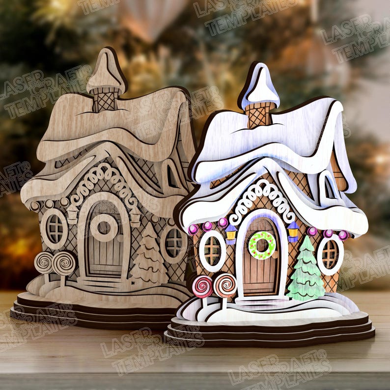 May include: Two wooden gingerbread house decorations. One is unfinished, the other is painted with white snow, colorful candies, and a green wreath on the door. The houses have intricate details and are designed for the holiday season.