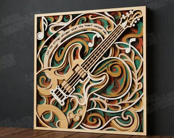 May include: A multi-layered wooden art piece featuring a guitar design with musical notes and swirling patterns in shades of brown, green, orange, and white. The text "Let the strings whisper what the heart cannot say" is included.