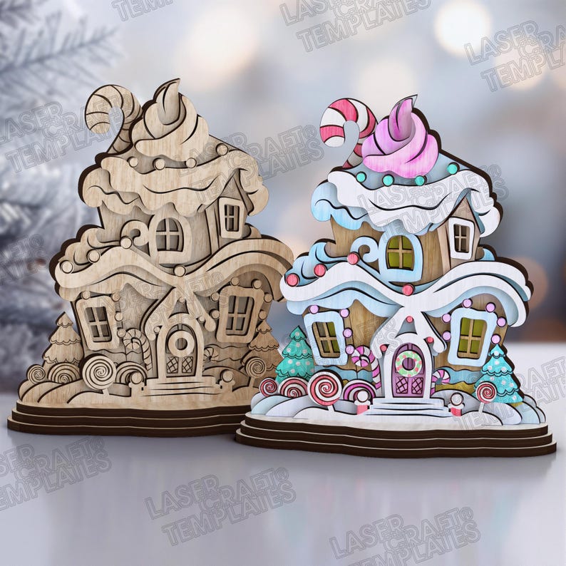 May include: Two gingerbread house ornaments. One is unpainted wood, the other is painted with pastel colors, candy accents, and a pink swirl on top. Both have windows, doors, and candy cane details. The ornaments are on a brown base.