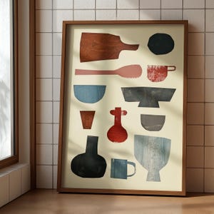 Peut inclure: Une affiche encadrée présentant des formes abstraites d'ustensiles de cuisine de différentes couleurs. L'œuvre comprend une planche à découper en bois, une cuillère, des bols, une tasse et un vase. La palette de couleurs comprend des nuances de marron, de rouge, de bleu et de noir.