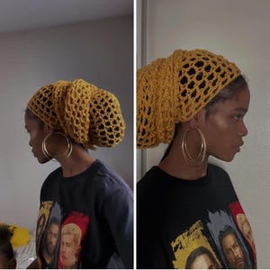 May include: Mustard yellow crochet head covering with a loose, open weave. The head covering is paired with large gold hoop earrings and a black graphic t-shirt. The t-shirt features images of several people.