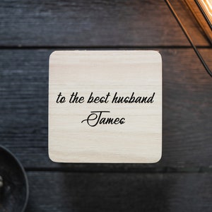 May include: A wooden coaster with the text "to the best husband -James" engraved on it.