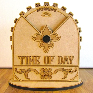 May include: Wooden time of day clock with a decorative floral design. The clock features a circular dial with numbers and the word "MORNING". The words "TIME OF DAY" are displayed on the front.