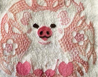 Débarbouillette avec motif cochon rose brodé et savon assorti.
