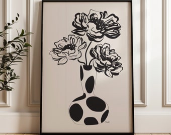 May include: Black and white line art print of three flowers in a black and white polka dot vase. The print is framed in a black frame.