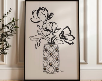 May include: Black and white line art print of a vase with flowers. The vase is decorated with a geometric pattern in gold. The print is signed "Saxe".