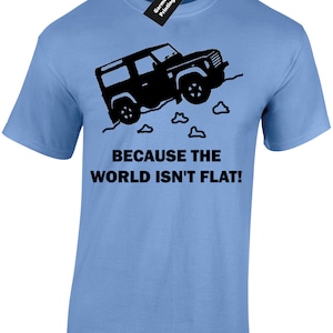 May include: A light blue t-shirt featuring a black silhouette of a vehicle driving over a hill with the text "Because the world isn't flat!"