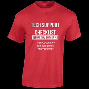 May include: Red t-shirt with white text that reads "Tech Support Checklist Before You Bother Me" and a list of questions: "Is it plugged in? Is it turned on? Are you sure?"